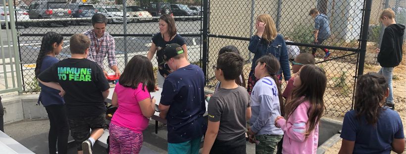 picture of children and community leaders engaging in an outdoor activity together